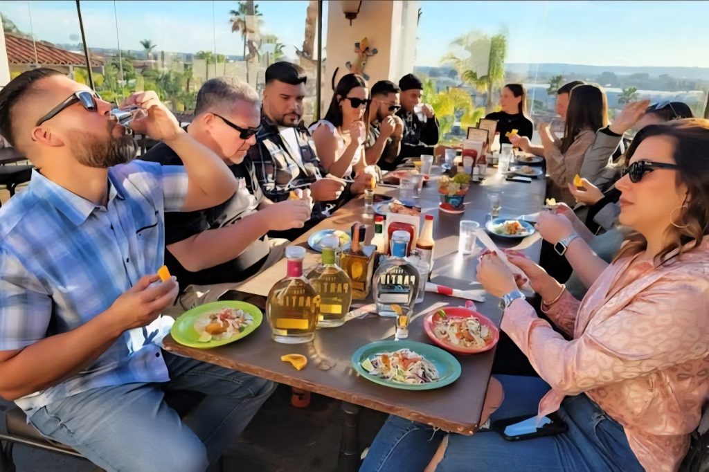 Guests sharing tacos and tequila tasting flights on a rooftop in Old Town San Diego